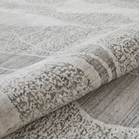 white blue abstract rug closeup partially rolled