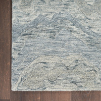 blue abstract rug closeup corner on wood floor