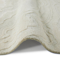 ivory abstract rug closeup folded on white background