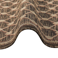 brown rug partially folded on a white floor