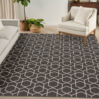 black geometric indoor outdoor rug in a room