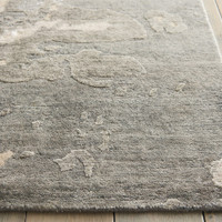 sand abstract rug closeup edge on wood floor