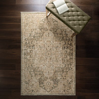 green traditional rug in a living room with matching decor