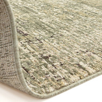 green abstract rug partial fold on white floor