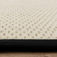cream wool jute rug  edge on wood floor