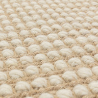 cream wool jute rug edge on wood floor