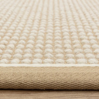 cream wool jute rug  edge on wood floor