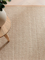 cream wool jute rug  edge on wood floor