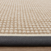 cream wool jute rug edge on wood floor