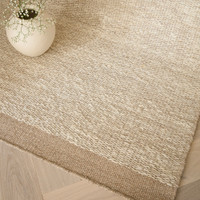 sand flatweave wool rug closeup border with plant pot