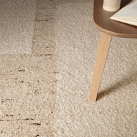 beige wool rug closeup detail with side table