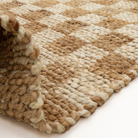 natural jute rug partial fold on white floor