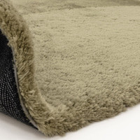 sage shaggy rug partial fold on white floor