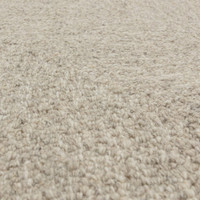 Macro texture shot showcasing the raised chevron pattern weave and soft premium fibers of a neutral sand wool area rug.