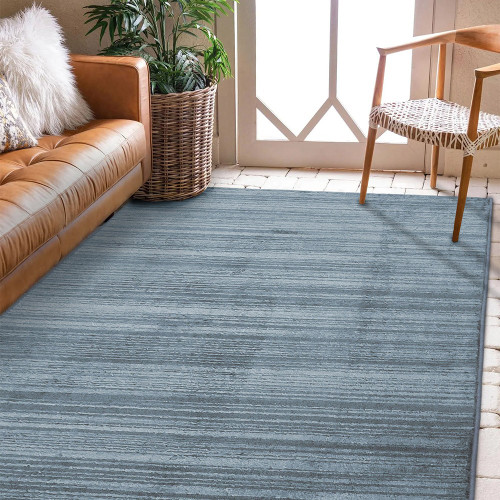 Arlo Textured Blue Rug in a living space with a seating arrangement
