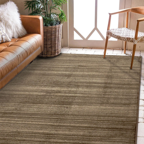 Arlo Textured Natural Rug in a living space with a seating arrangement.