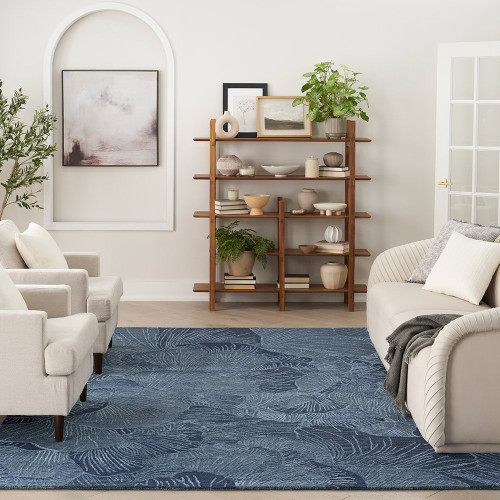 blue floral patterned rug in between white sofas in a living room