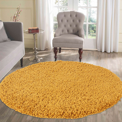 plain shaggy gold circle rug in a living room