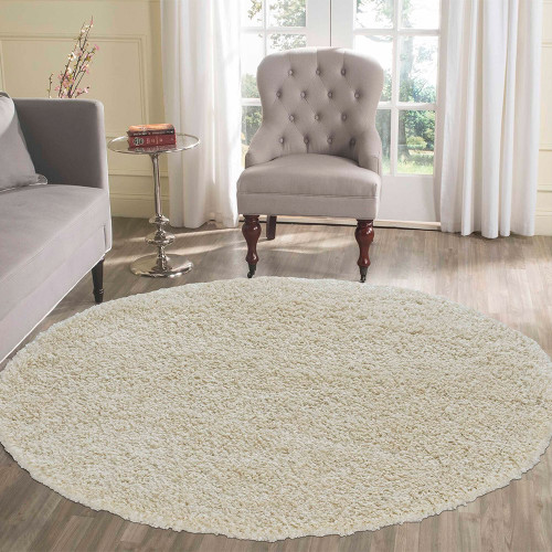 plain shaggy ivory circle rug in a living room