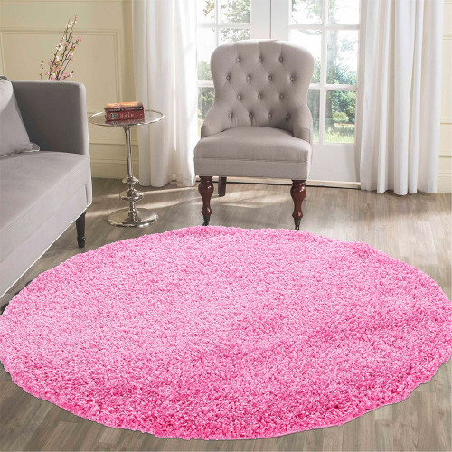 plain shaggy pink circle rug in a living room