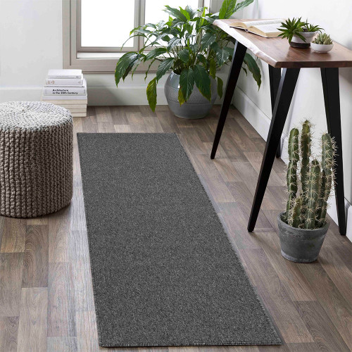 plain low pile dark grey rug runner in a living space