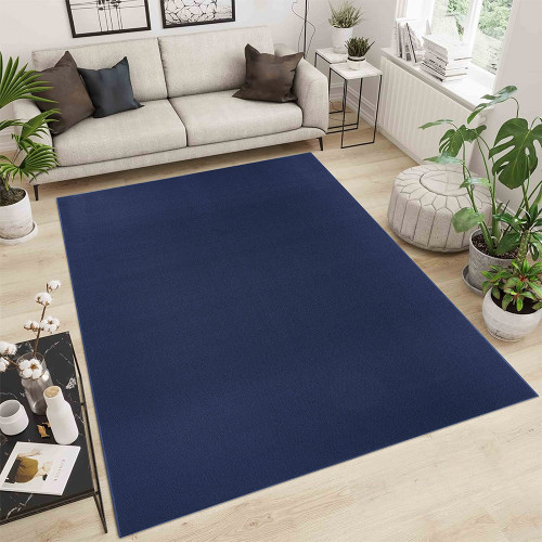 plain low pile navy rug in a living room with a wooden floor