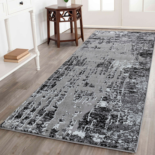 modern abstract abrasion black rug runner in a hallway