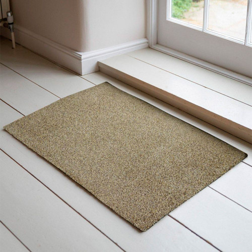 beige dirt trapper doormat in a doorway