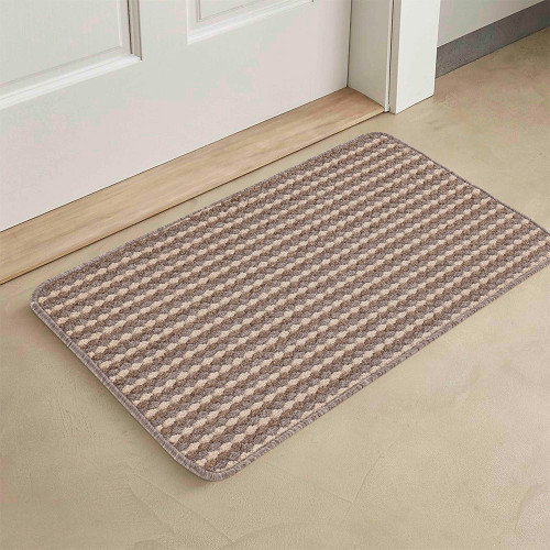 beige non-slip dirt trapper mat in front of a door indoors