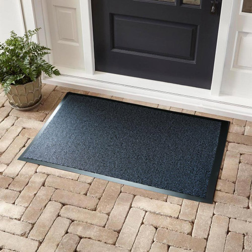 blue non-slip dirt trapper mat in front of a door outdoors