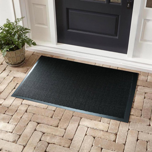 charcoal non-slip dirt trapper mat in front of a door outdoors