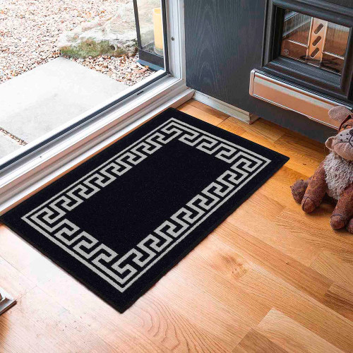 greek key black doormat in a door way on a wood floor