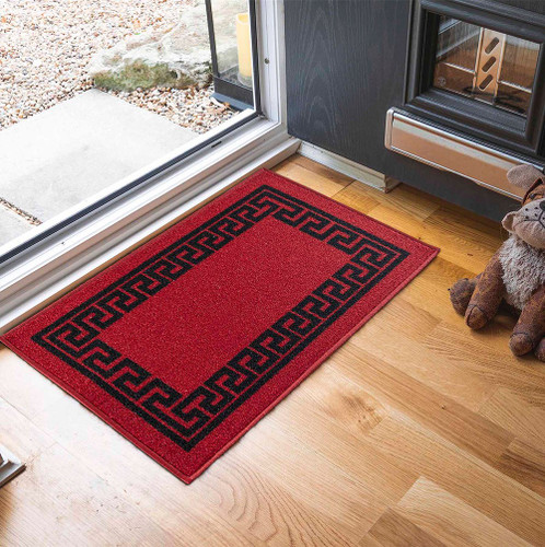 greek key red and black doormat in a door way on a wood floor