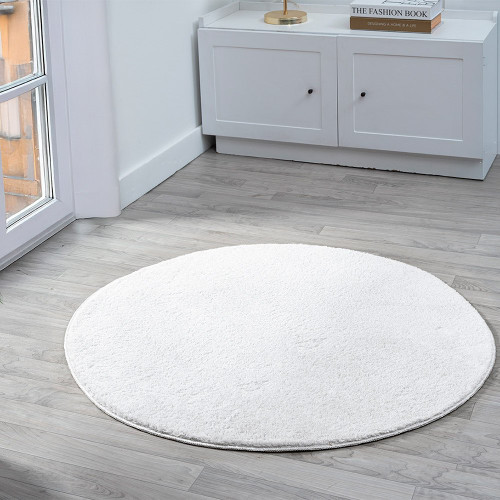 plain silver rug circle in a living space with a window