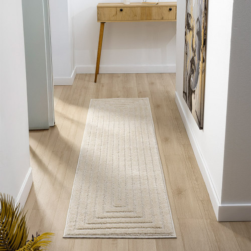 border cream rug runner in a hallway