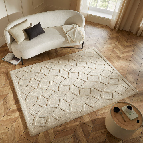 beige wool rug in a living room with natural decor