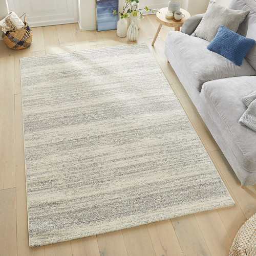 grey striped rug in a living room with matching decor