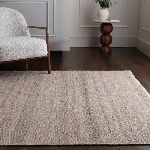 beige plain rug in a living room with matching decor