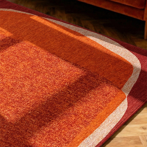 orange abstract eco rug in a bedroom room with matching decor