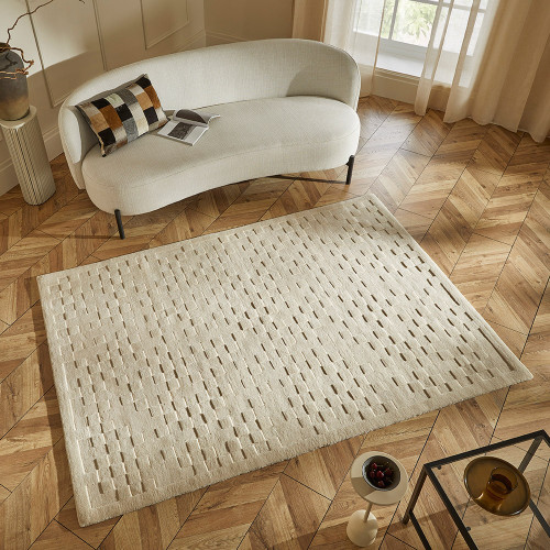 ivory wool rug in a living room with natural decor