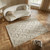 taupe wool rug in a living room with natural decor