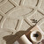 taupe wool rug closeup with a bowl and book