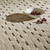 taupe wool rug closeup with bowl of fruit