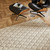 ivory wool rug in a living room with natural decor