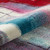 multicolour abstract rug closeup partially rolled