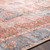 rust traditional rug closeup detail on dark wood floor