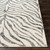 charcoal zebra pattern rug closeup corner on a wood floor