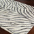 charcoal zebra pattern rug in a room with matching decor
