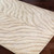 grey zebra pattern rug closeup corner on a wood floor