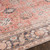 orange traditional rug closeup detail on wood floor
